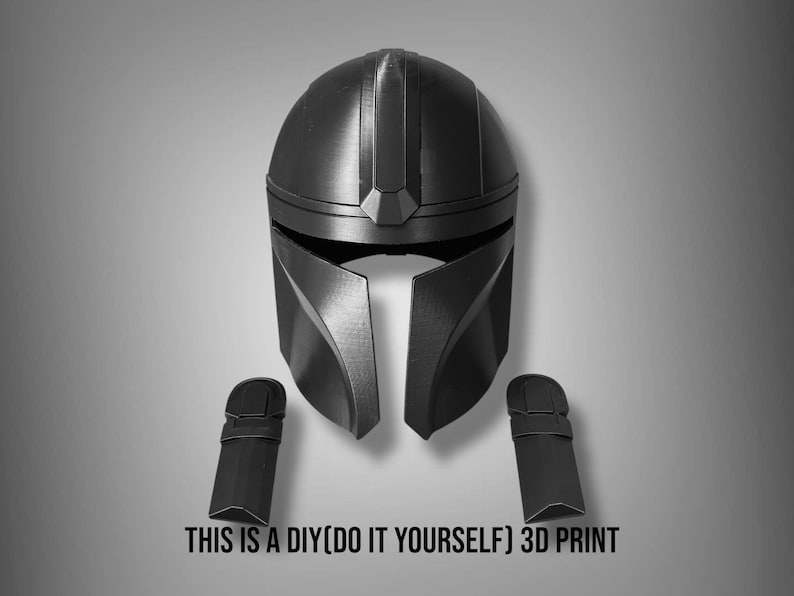 Puede incluir: Un casco negro impreso en 3D y dos piezas de brazo a juego. El casco tiene un dise&ntilde;o distintivo con una visera y una cresta central. El texto en la parte inferior dice "THIS IS A DIY(DO IT YOURSELF) 3D PRINT".