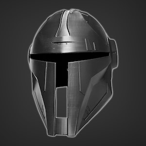 May include: A black helmet with a futuristic design. The helmet has a visor and a series of lines and grooves on the surface.