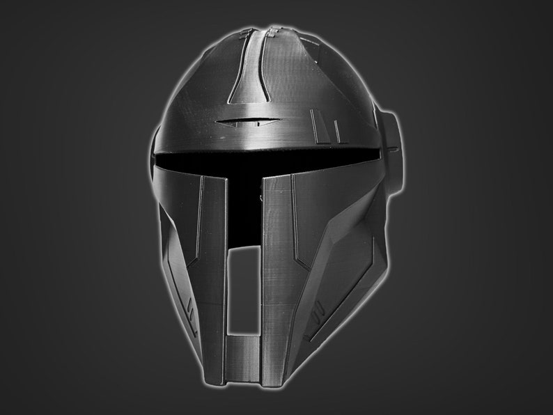 May include: A black helmet with a futuristic design. The helmet has a visor and a series of lines and grooves on the surface.