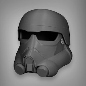 May include: A black and gray plastic helmet with a visor and a breathing apparatus. The helmet has a textured surface and a rounded shape.