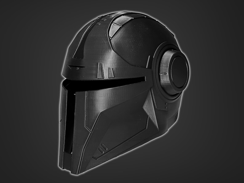 May include: A black helmet with a futuristic design. The helmet has a visor and a round, black earpiece on the right side.