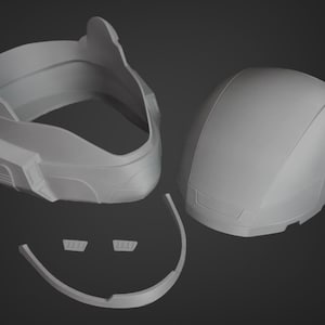Puede incluir: Un casco de pl&aacute;stico gris con m&uacute;ltiples piezas, incluyendo una parte superior, una inferior y una visera. El casco est&aacute; dise&ntilde;ado para ser ensamblado.