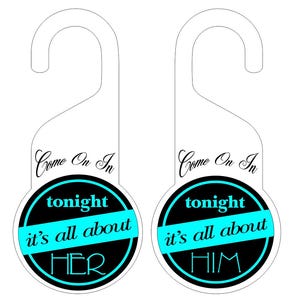 May include: Two white door hangers with a curved top and a circular design. The design features the text "Come On In" in cursive, and a black circle with the words "tonight", "it's all about", and either "HER" or "HIM" in a teal color.
