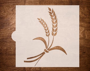 May include: A white stencil featuring a design of wheat stalks. The stencil is made from a thin, flexible material and is intended for use with paint or other mediums.