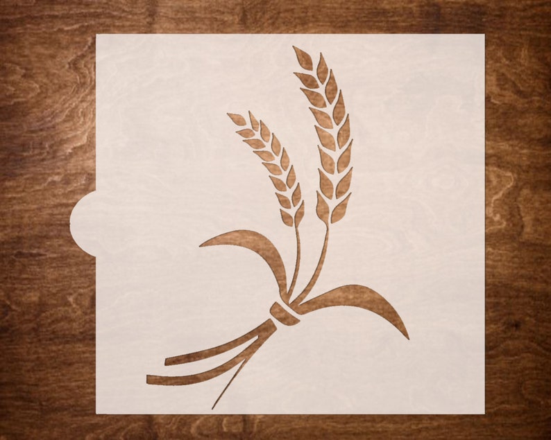 May include: A white stencil with a design of wheat stalks. The stencil is made of a thin, flexible material and is designed for use with paint or other mediums.