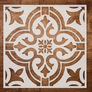 May include: White stencil of a decorative tile pattern with a floral design. The stencil is made of a thin, flexible material and is designed to be used with paint or other mediums.