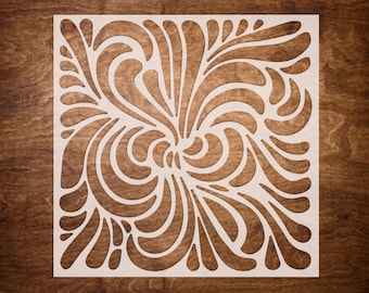 May include: White stencil with a swirling, floral design. The design is intricate and detailed, with many curves and loops.