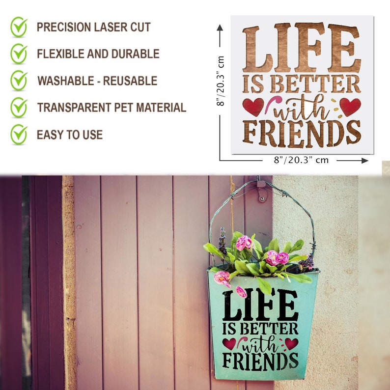 May include: A teal blue metal planter with the text "Life is better with friends" in black lettering and two pink hearts. The planter is hanging from a wire hook on a wooden wall.