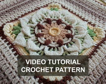 May include: Close-up of a crocheted square with a floral design in shades of brown, cream, white, and green. The text "VIDEO TUTORIAL CROCHET PATTERN" is displayed on the image.