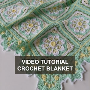 May include: A crochet blanket with a green, white, and yellow floral pattern. The blanket has a scalloped edge and the text "VIDEO TUTORIAL CROCHET BLANKET" is displayed on the image.