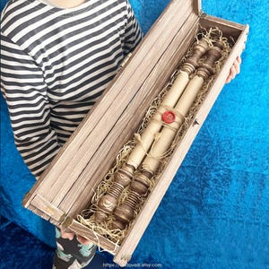 Medieval paper scroll with rustic wooden gift case