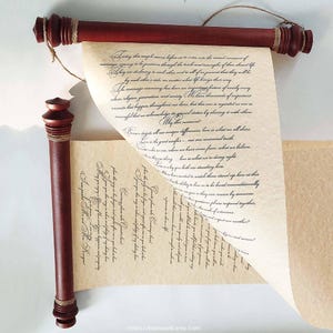 May include: A decorative scroll with a dark red wooden frame and a cream-colored paper. The paper is rolled at both ends and tied with twine. The scroll contains handwritten text in black ink, perfect for a wedding ceremony or special occasion.