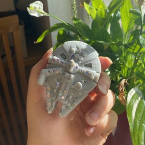 May include: A gray Millennium Falcon-shaped soap with silver glitter accents.