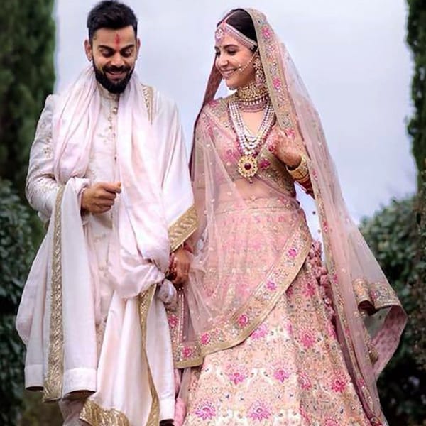 Sabyasachi Anushka Sharma Peach Embroidered Silk Bridal Wear Lehenga Choli Showcasing a beautiful Gleaming peach colored sabyasachi bridal