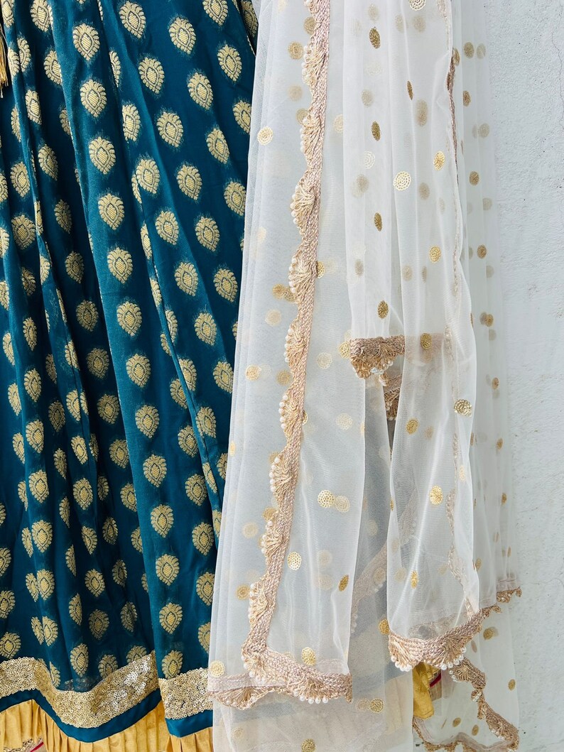 A Teal Blue Lehenga Skirt Set is a Custommade Choli With a Net Dupatta