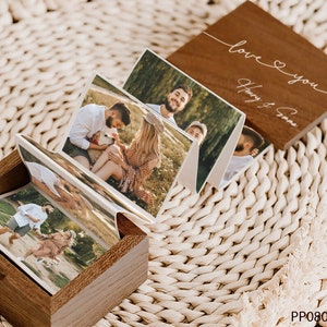 May include: A wooden box with a hinged lid, containing a mini photo album with several pictures of a couple. The lid of the box has the text "love you" and "Harry & Emma" engraved on it.