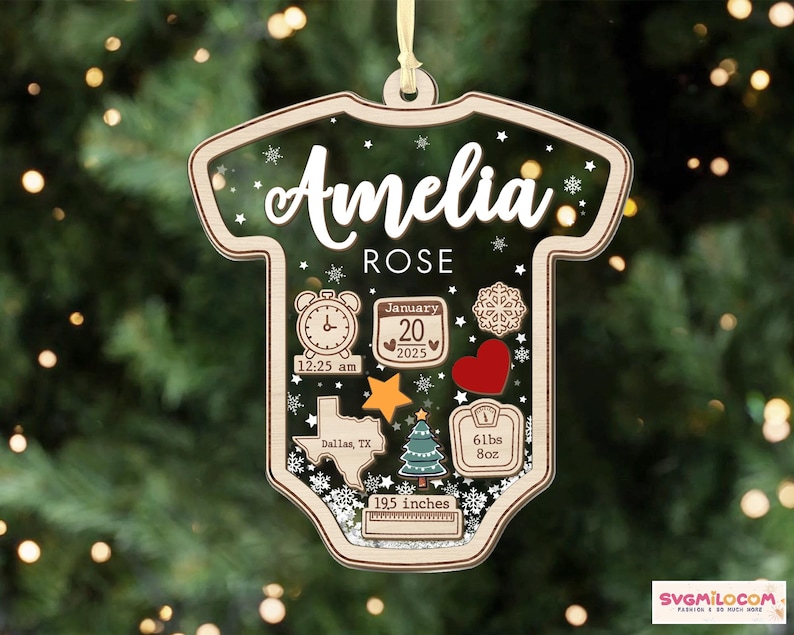 May include: A baby bodysuit-shaped wooden ornament featuring the name Amelia Rose, birth date January 20, 2025, time 12:25 am, location Dallas, TX, weight 61 lbs 8 oz, and length 19.5 inches, decorated with a clock, heart, star, and tree.