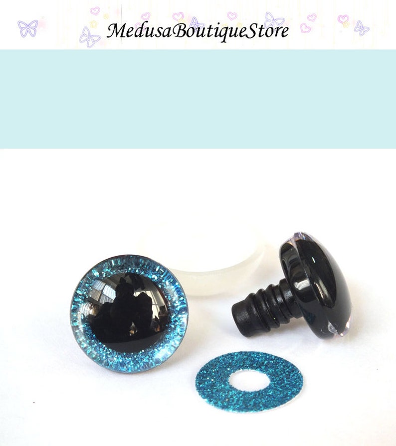 May include: A pair of black safety eyes with a blue glitter trim, a washer, and a plastic back for attaching the eyes to a stuffed animal or craft project.