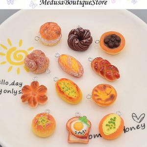 May include: Assortment of 12 miniature food charms, featuring various baked goods like bread, pastries, and donuts. The charms are made of polymer clay and have realistic details. They are perfect for adding a touch of whimsy to jewelry, keychains, or other crafts.