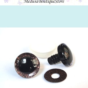May include: A set of black plastic safety eyes for stuffed animals or crafts. The eyes are 12mm in diameter and have a brown glitter rim. The set includes a washer and a plastic screw-on back.