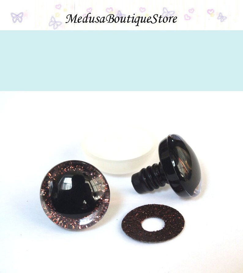 May include: A set of black plastic safety eyes for stuffed animals or crafts. The eyes are 12mm in diameter and have a brown glitter rim. The set includes a washer and a plastic screw-on back.
