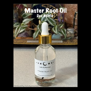 May include: A clear glass bottle labeled "Master Root Oil" with a white and gold dropper. The label includes the text "Spells By Moonlight" and a crescent moon design. The bottle contains a brown root and is 2oz.