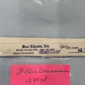 May include: A package of Bear Threads, Ltd. fabric, labeled "Blue 100% Cotton." The label includes the company's address in Atlanta, Georgia, and states the fabric was made in Switzerland. A pink sticky note reads "Lt. Blue Blammasran 12.75 yd."