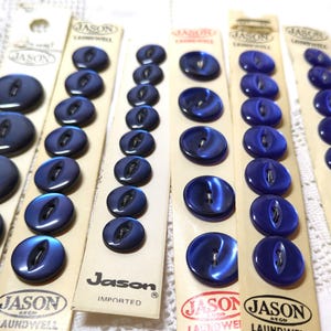 May include: A set of ten blue plastic buttons with a shiny finish. The buttons are packaged on cards with the brand name "Jason" printed on them.