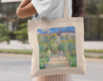 May include: Beige canvas tote bag featuring a colorful painting of a garden path lined with sunflowers. The artwork depicts a sunny day with a house in the background. The bag has a simple design with long straps.