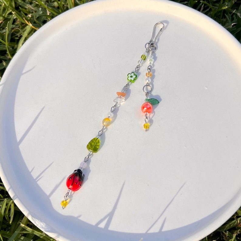 Vibrant colorful, earth tones that compliment the energy of this rear view mirror accessory. It can also be used as a purse accessory, suncatcher, or hang it anywhere!