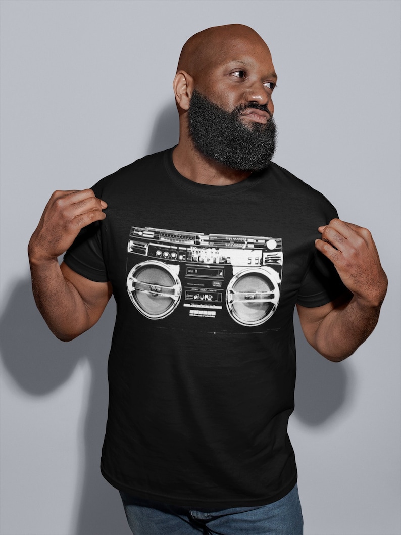 May include: A black t-shirt with a white graphic of a vintage boombox.