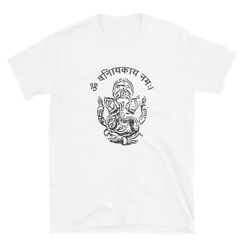 May include: White t-shirt with a black and white image of the Hindu deity Ganesha. The image is surrounded by a circle with the text "ॐ विनियकाय नमः" in Sanskrit.