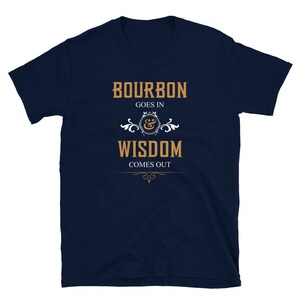 May include: Navy blue t-shirt with a gold graphic that reads "Bourbon goes in & Wisdom comes out".