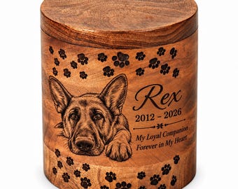 May include: A cylindrical wooden urn featuring a laser-engraved German Shepherd portrait, scattered paw prints, and the text: Rex, 2012-2026, My Loyal Companion, Forever in My Heart. The natural wood grain is visible across the surface.