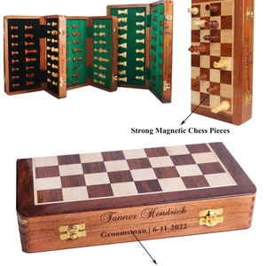 May include: A wooden chess set with a magnetic board and pieces. The set is shown open, revealing the pieces stored in felt-lined compartments. The set is engraved with the name "Tanner Hendrick" and the text "Groomsman | 6-11-2022".