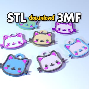 May include: Six 3D printed cat head charms in various colors, including pink, blue, purple, white, and yellow. The charms are outlined in black and have pink cheeks. The text "STL download 3MF" is displayed at the top of the image.