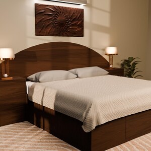 May include: A dark wood bed frame featuring a curved headboard, integrated storage drawers in the base, and two matching bedside tables. The bed is dressed in a light-coloured, textured quilt with two pillows, flanked by two lamps with warm glowing shades.
