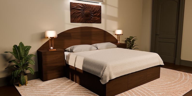 May include: A dark wood bed frame featuring a curved headboard, integrated storage drawers in the base, and two matching bedside tables. The bed is dressed in a light-coloured, textured quilt with two pillows, flanked by two lamps with warm glowing shades.