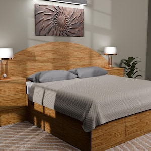 May include: A wooden bed frame with a large, arched headboard and integrated storage drawers at the base. The bed is dressed in a light gray, textured quilt with two matching pillows. Two wooden nightstands with lamps flank the headboard.