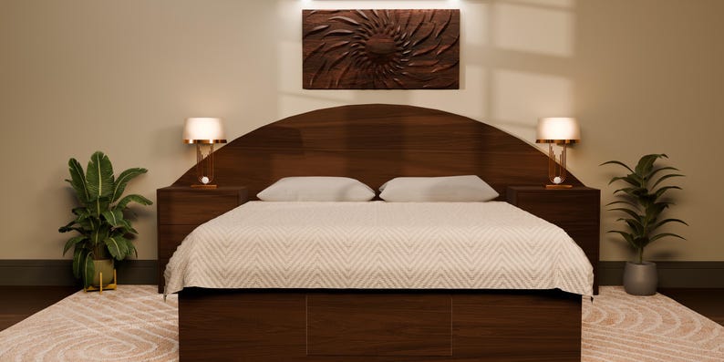 May include: A dark wood bed frame featuring a large, arched headboard and two matching nightstands. The bed is dressed in a white coverlet with a subtle chevron pattern. Two lamps with white shades sit on the nightstands, flanking the bed.