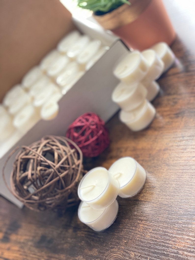 60-count wholesale soy tea lights. Hand poured natural soy wax with 100% cotton wicks. Poured in clear plastic tea light cups. Available in 12-count also. Scented and Unscented.