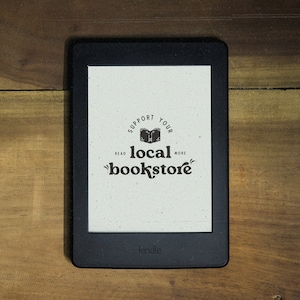 May include: A black and white image on a Kindle e-reader screen that says "Support Your Local Bookstore" with a stylized image of an open book. The text also says "Read More" and "Read Less".
