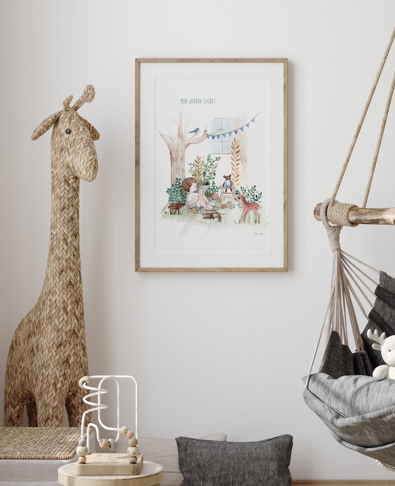 May include: A framed watercolour illustration of a child sitting in a forest clearing with a teddy bear and a deer. The text "Mon Jardin Secret" is at the top of the illustration.