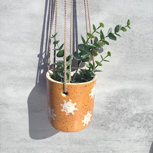 May include: A rustic wooden sign with the text "Welcome to our home" in white lettering. The sign features a distressed finish and a simple, inviting design, perfect for a front porch or entryway.