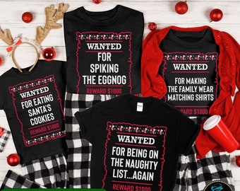 May include: Black t-shirts with humorous holiday-themed text. One says "WANTED FOR EATING SANTA'S COOKIES", another "WANTED FOR SPIKING THE EGGNOG", a third "WANTED FOR MAKING THE FAMILY WEAR MATCHING SHIRTS", and the last "WANTED FOR BEING ON THE NAUGHTY LIST...AGAIN".