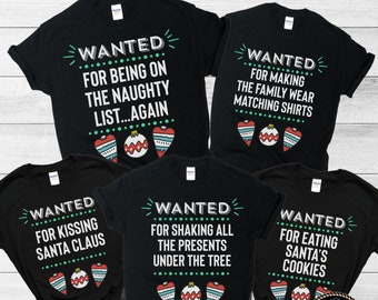 May include: Black t-shirts with various Christmas-themed phrases in white text, including "WANTED" and humorous statements like "FOR BEING ON THE NAUGHTY LIST...AGAIN." Each shirt features decorative ornaments. The listing is for the shirt only.