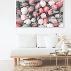 May include: A close-up image of a bunch of pink and white tulips. The tulips are arranged in a tight cluster, with the stems and leaves visible. The image is soft and romantic, with a vintage feel.