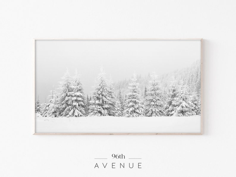Minimalist winter landscape featuring a row of snow-covered pine trees against a soft gray sky, calm Scandinavian-style digital wall art by 96thAvenue, designed for Samsung Frame TV, LG and Sony TVs, and high-resolution MacBook or monitor displays.