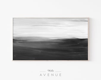 May include: Abstract black and white painting with a horizontal line dividing the canvas. The top half is a light gray with white brushstrokes, and the bottom half is a dark gray with black brushstrokes. The painting is framed in a light wood frame.