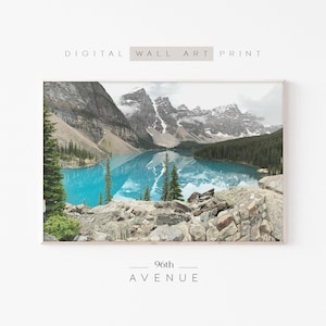 May include: Digital wall art print featuring a scenic landscape. The image showcases a turquoise lake surrounded by mountains and evergreen trees. The text "DIGITAL WALL ART PRINT" and "96th AVENUE" are displayed on the print.